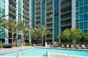 A large swimming pool in front of an apartment building